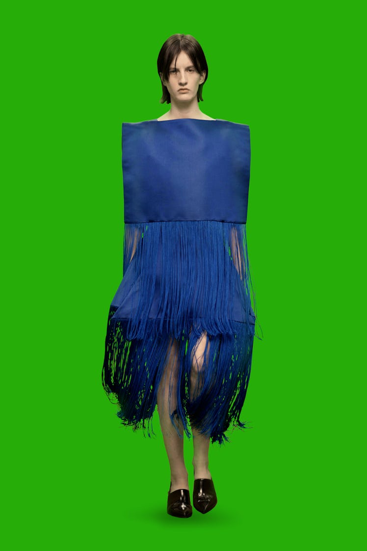 A model wearing a blue dress with fringed skirt part by Christopher Kane at the London Fashion Week ...