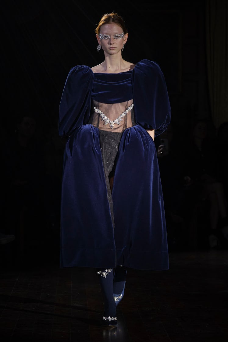 A model in a blue velvet dress with pearls by Simone Rocha at the London Fashion Week Fall 2022