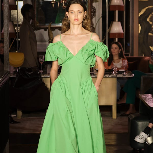 a model wearing a bright green midi dress on the Rejina Pyo runway