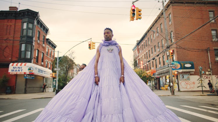 Billy Porter in an oversized violet dress on the road in Children 