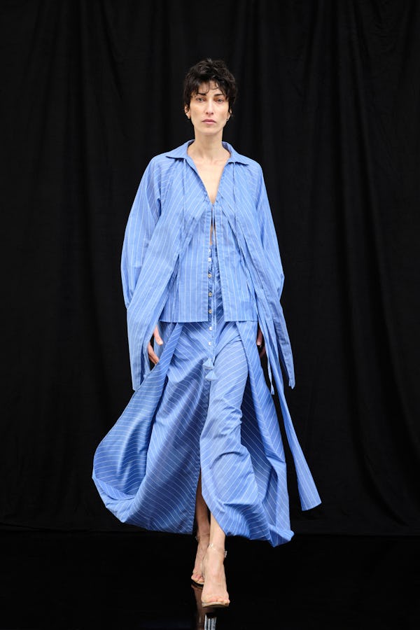 a model wearing a blue striped cotton poplin shirt and skirt on the Palmer//Harding runway