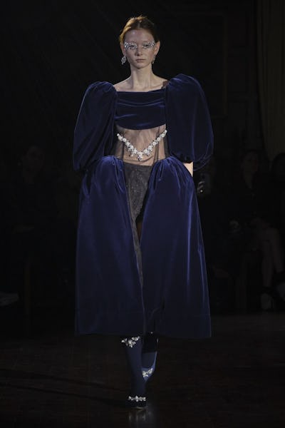 a model wearing a voluminous blue velvet dress on the Simone Rocha runway