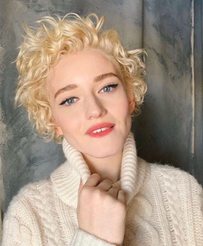 Julia Garner showing off a pixie-length shag with curly hair.