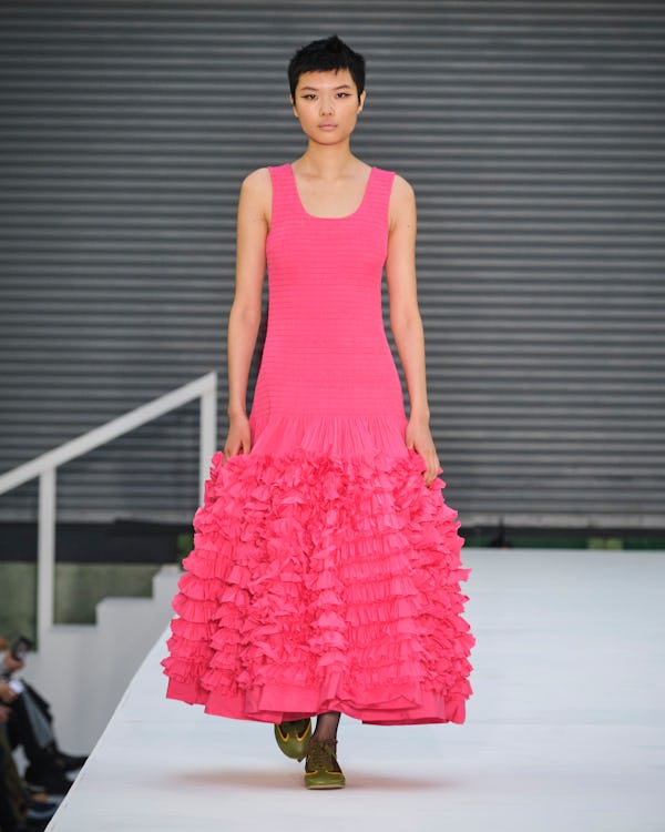 a model wearing a voluminous hot pink dress on the Molly Goddard runway