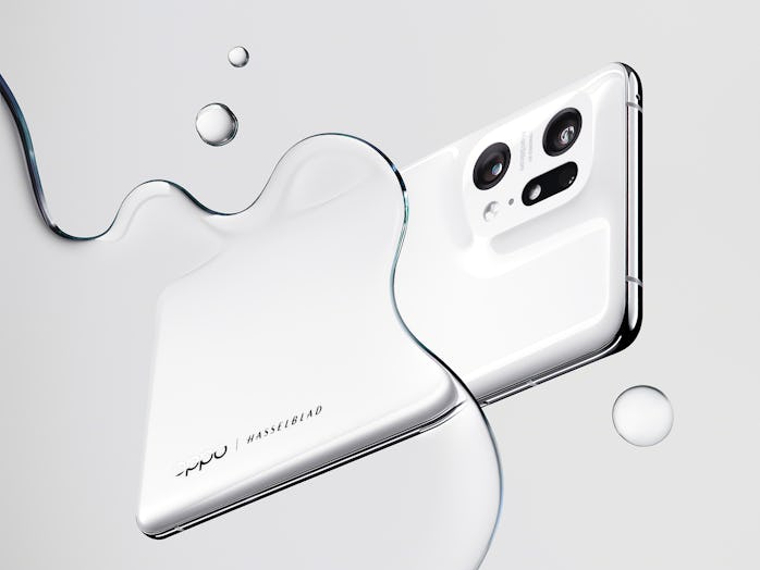 The white Oppo Find X5 Pro in a puddle.