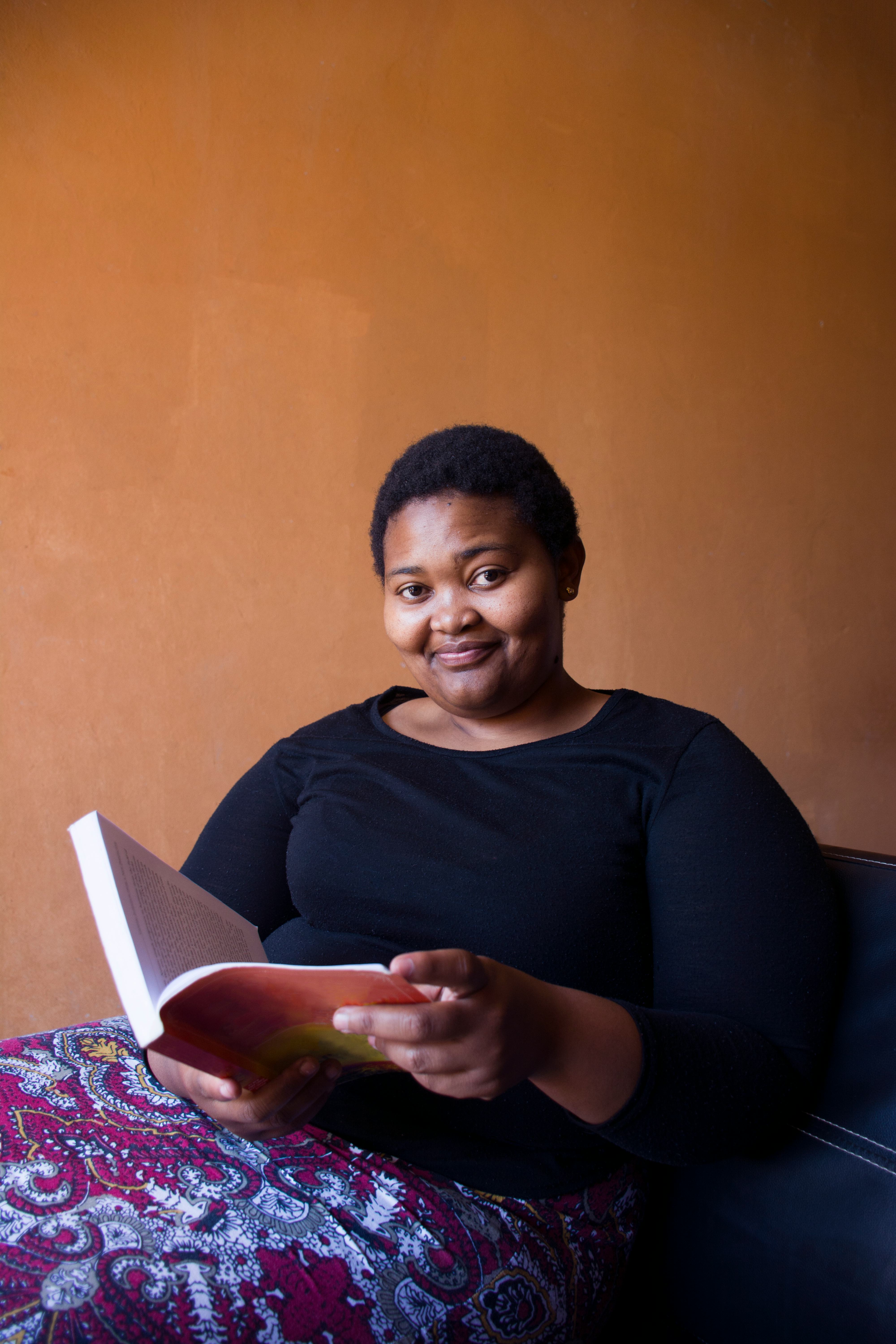 Young woman reading a book, since she's one of the zodiac signs who love to read most.