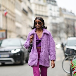 Woman wears a purple outfit.