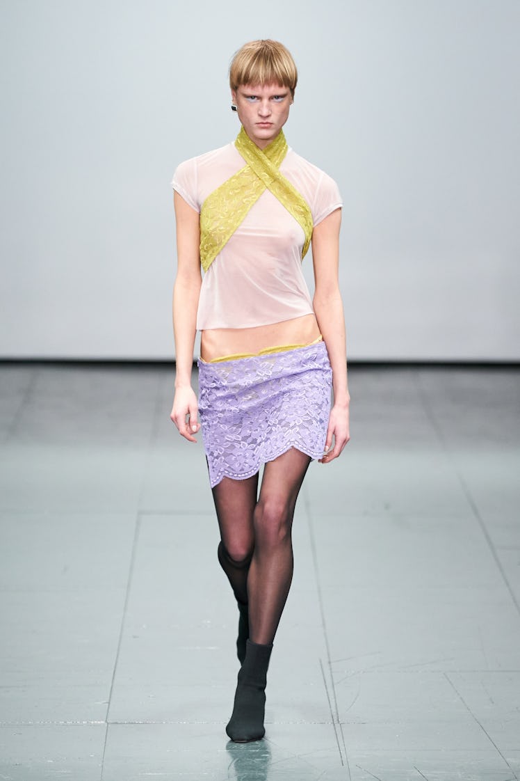 A model wearing a white-yellow Supriya Lele top and lilac lace dress at the London Fashion Week Fall...