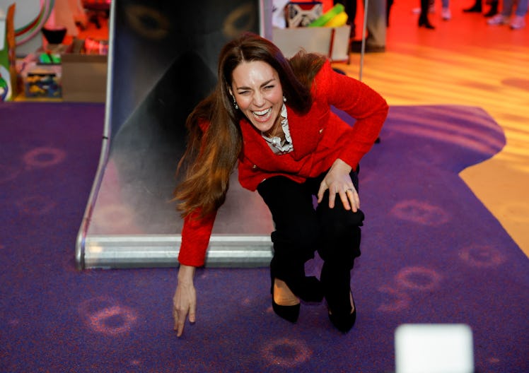 Kate Middleton laughing after going down a slide