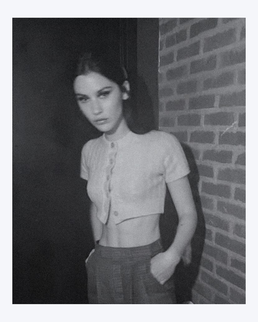 Gracie Abrams posing in a white Celine blazer top