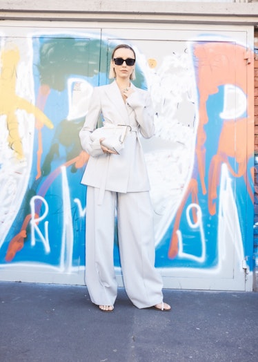 A person wearing a white suit at Milan Fashion Week