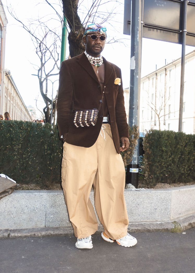 A person wearing large tan pants at Milan Fashion Week