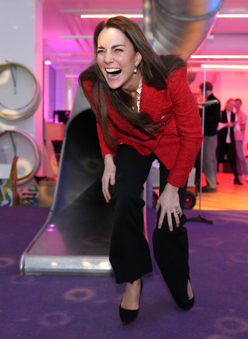 Kate Middleton laughing after going down a slide