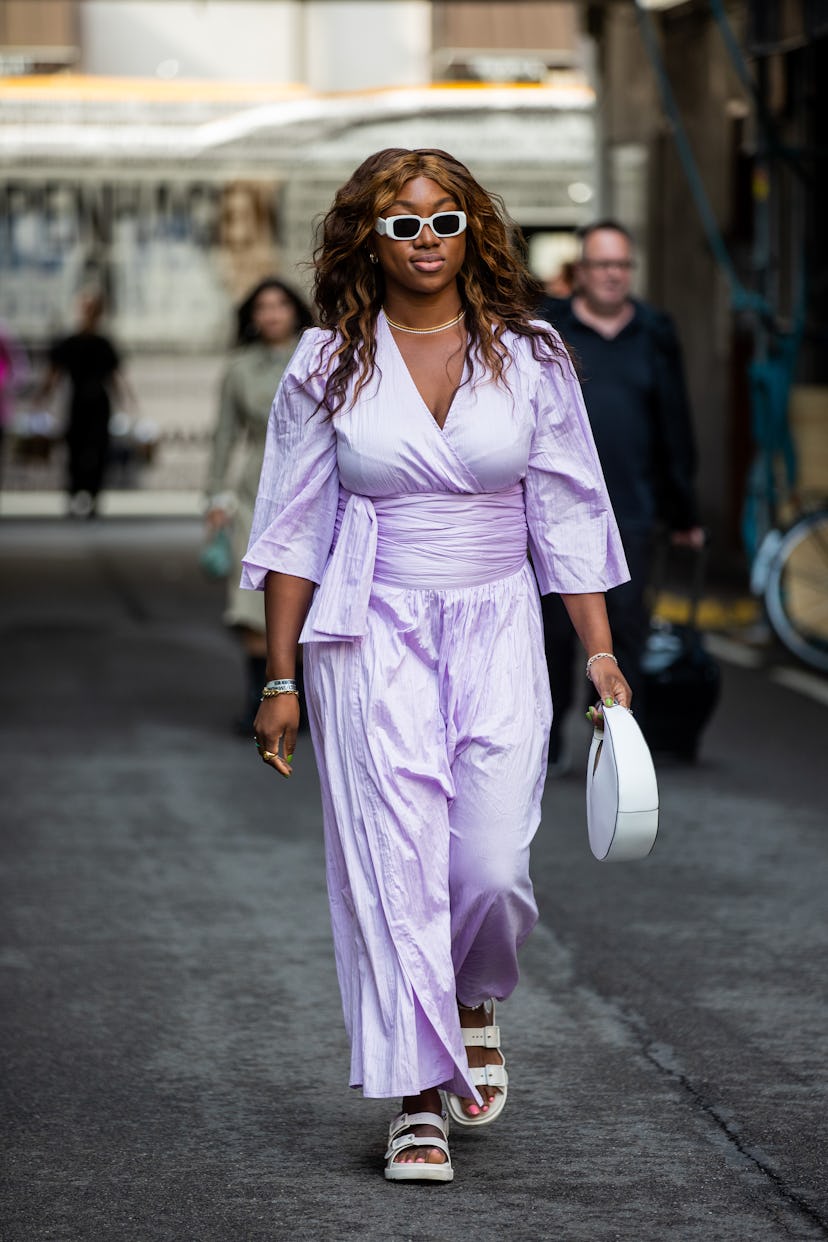 Woman wears a purple outfit