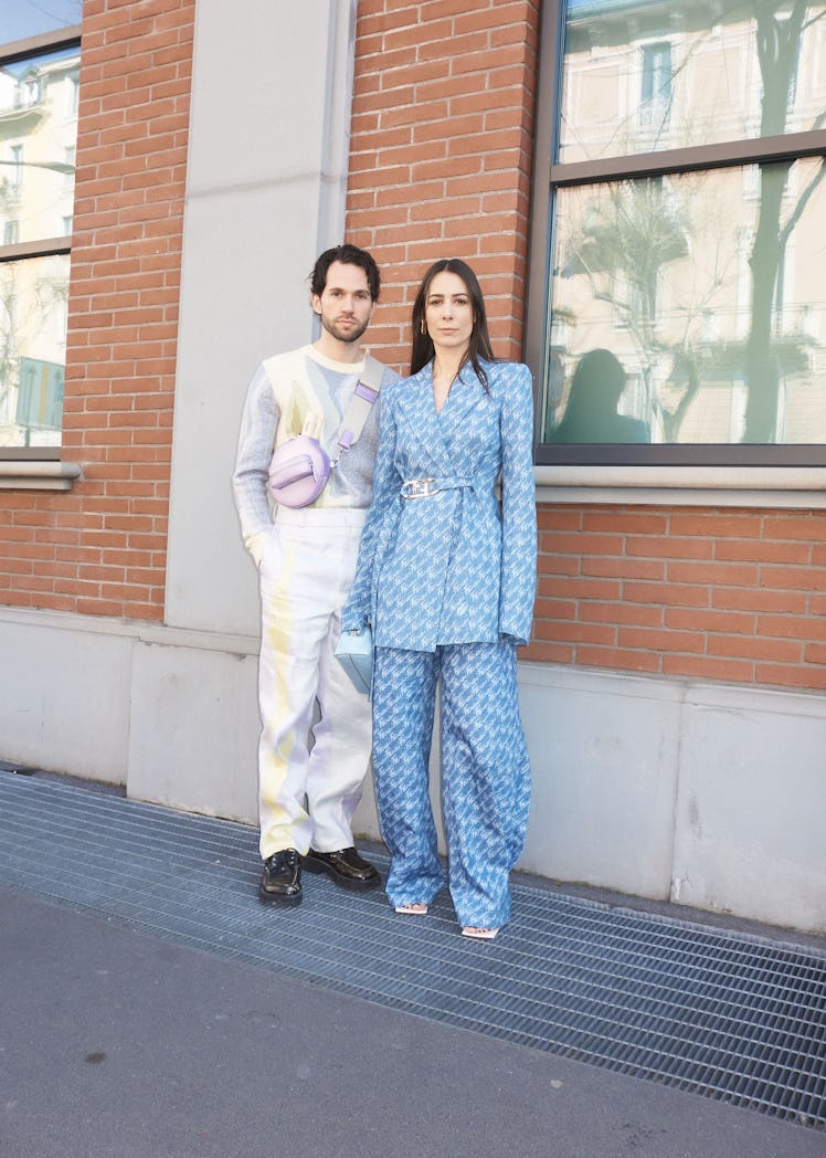 Two people standing outside of Milan Fashion Week