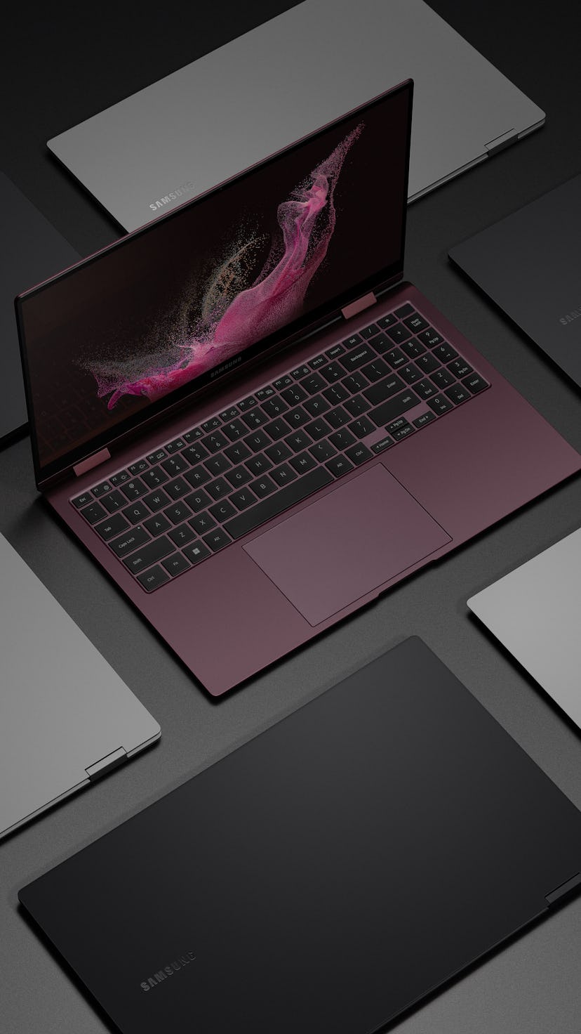 The Galaxy Book 2 Pro 360 in burgundy sitting open surrounded by closed Galaxy Books