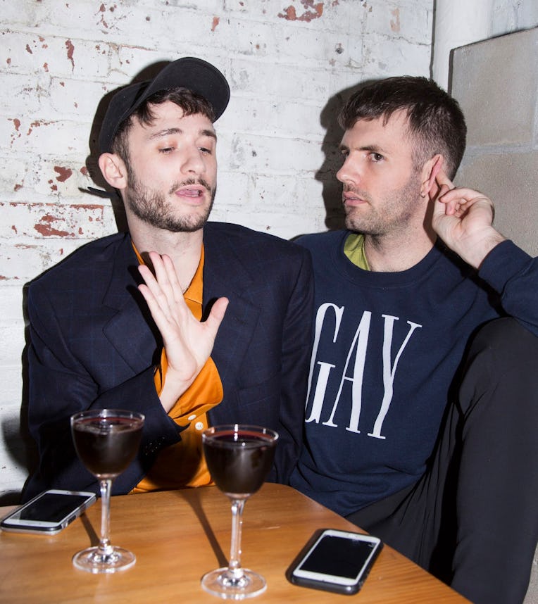 Eric Schwarau and Steven Phillips-Horst explaining something while drinking wine.