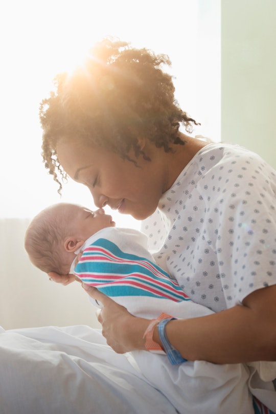 new mom holding newborn baby in the hospital