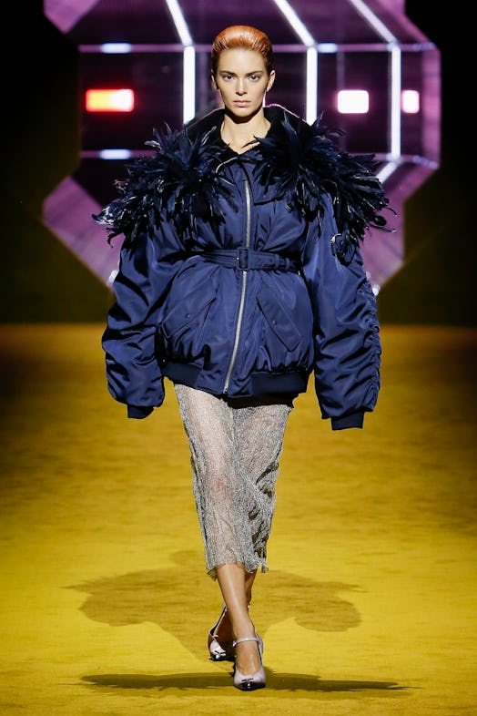 Kendall jenner wearing prada fall winter 2022 bomber jacket with feathers and sheer skirt