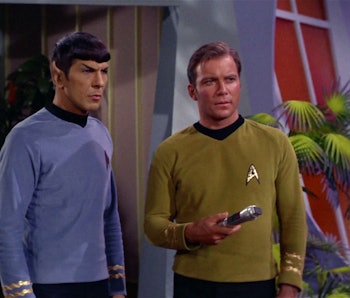 Spock and Kirk, holding a universal translator. 