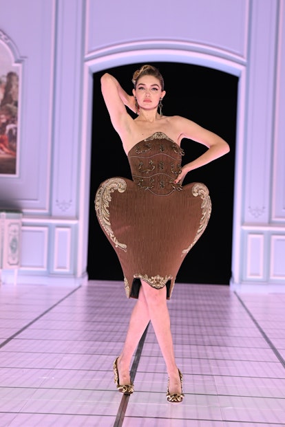 Gigi Hadid wearing a dress shaped like a bureau at Moschino fall 2022