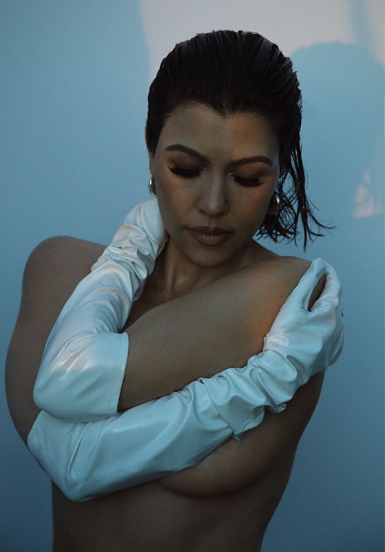 Kourtney Kardashian wearing only Angharad earrings and Wing & Weft gloves, looking down 