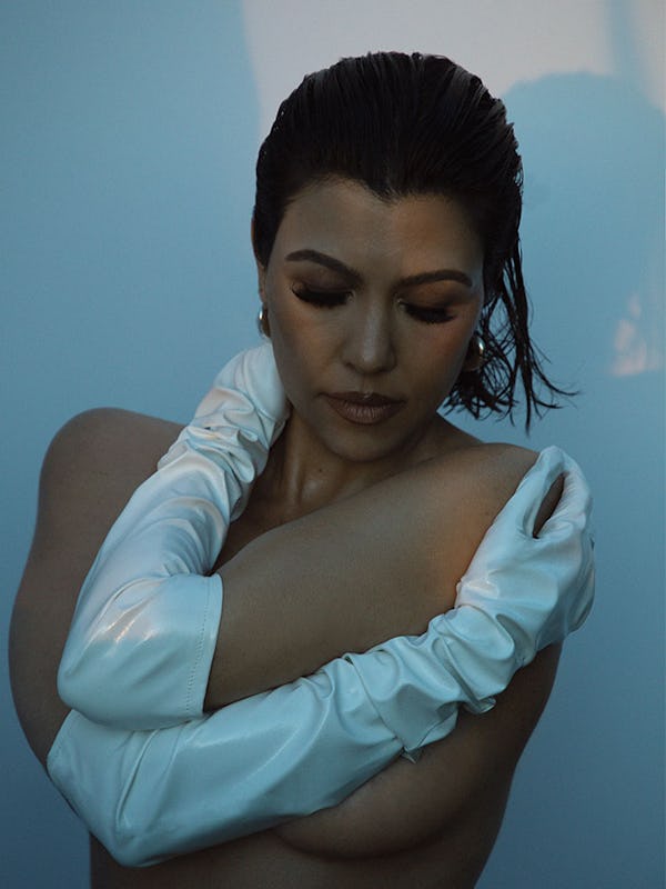 Kourtney Kardashian wearing only Angharad earrings and Wing & Weft gloves, looking down