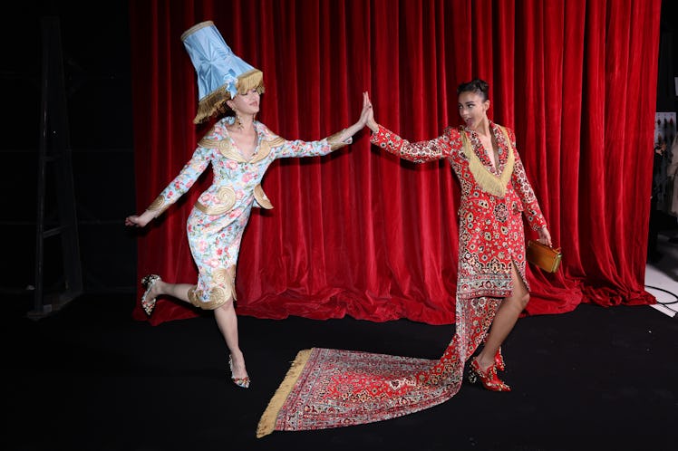 Two Moschino models dressed as a lamp and a rug