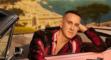 Jeremy Scott in a pink car, carrying his Furturna Skin collector's edition set