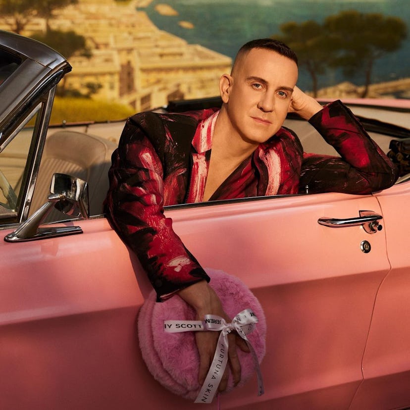 Jeremy Scott in a pink car, carrying his Furturna Skin collector's edition set