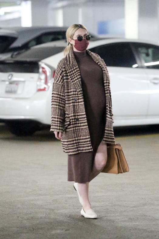Emma Roberts wears Zara brown knit dress.