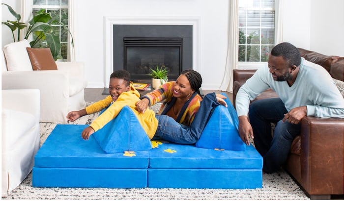 child playing on The Nugget couch with family