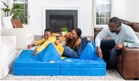 child playing on The Nugget couch with family 