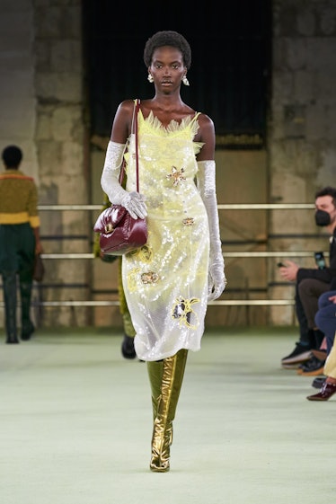 Model wearing yellow dress with opera gloves at Bottega Veneta Milan fashion week