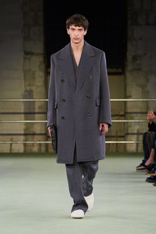 A model in an oversize coat walks in the Bottega Veneta show at Milan Fashion Week