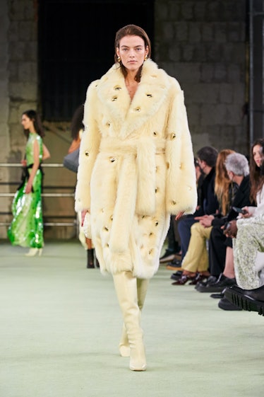 Model in butter yellow coat at Bottega Veneta fall 2022
