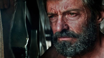 Hugh Jackman looking out a window as Wolverine in 2017's Logan