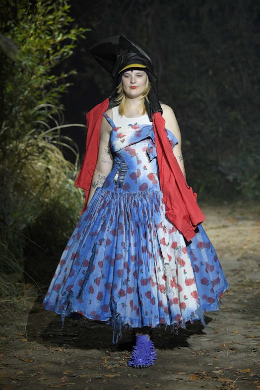 A model in a blue and white dress with red accents walks the runway at Marni fall 2022 Milan fashion...