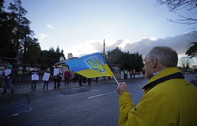 A protester in Dublin holding a flag with the Ukrainian coat of arms on Feb. 28, 2022. 