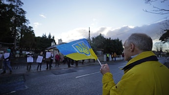 A protester in Dublin holding a flag with the Ukrainian coat of arms on Feb. 28, 2022. 