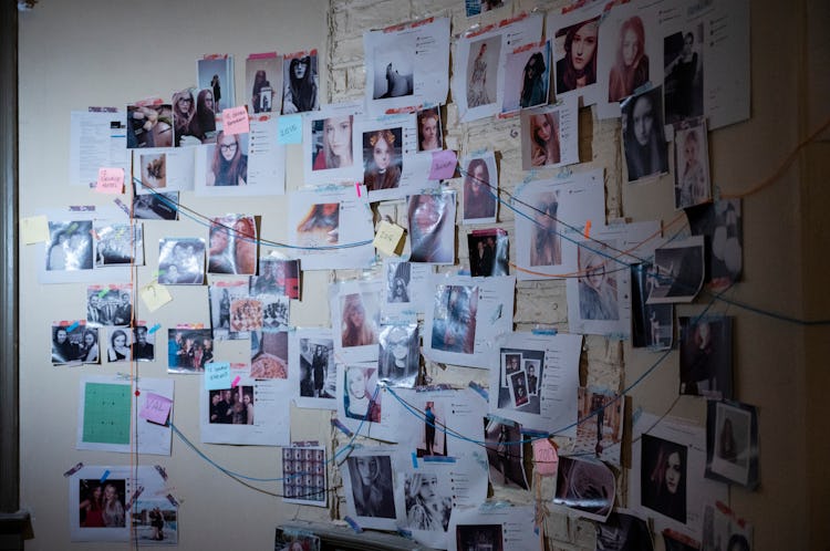 A wall of photos, mostly of Anna Delvey, with red string connecting them a la television investigati...