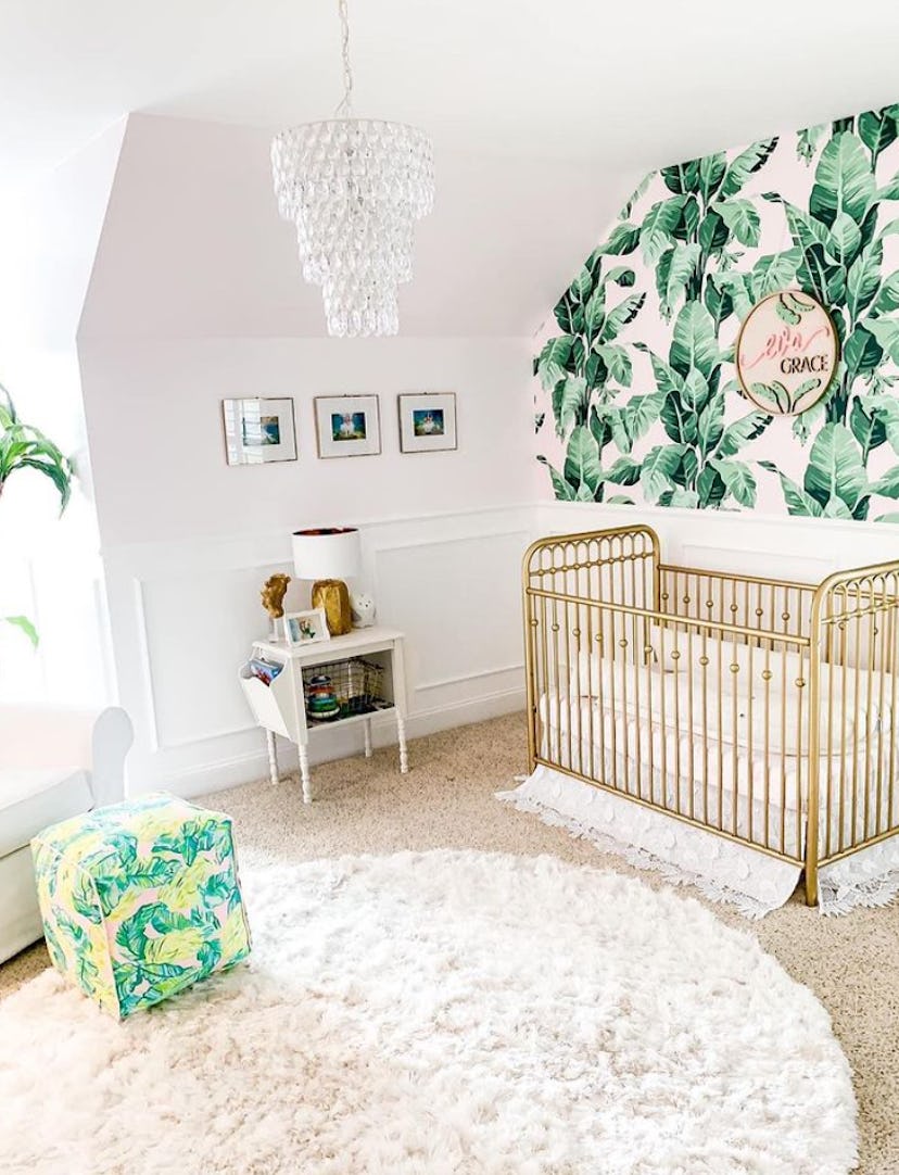 Baby girl nursery with palm wallpaper