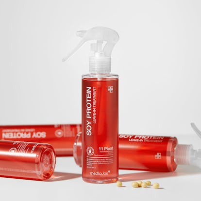 three bottles of Medicube Soy Protien Leave-in Treatment lying on white background with one standing...