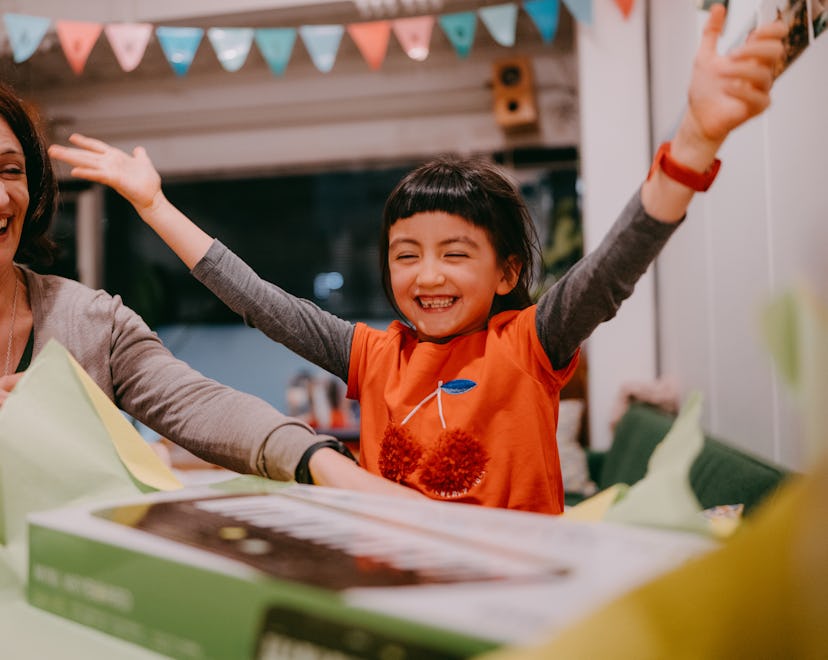 excited kid who practically has everything opening a gift