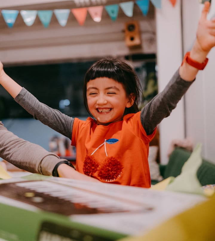 excited kid who practically has everything opening a gift 