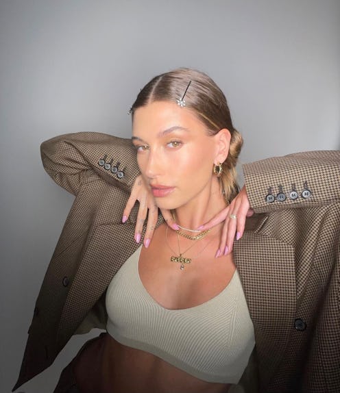 Hailey Bieber wearing a bralette with a blazer.