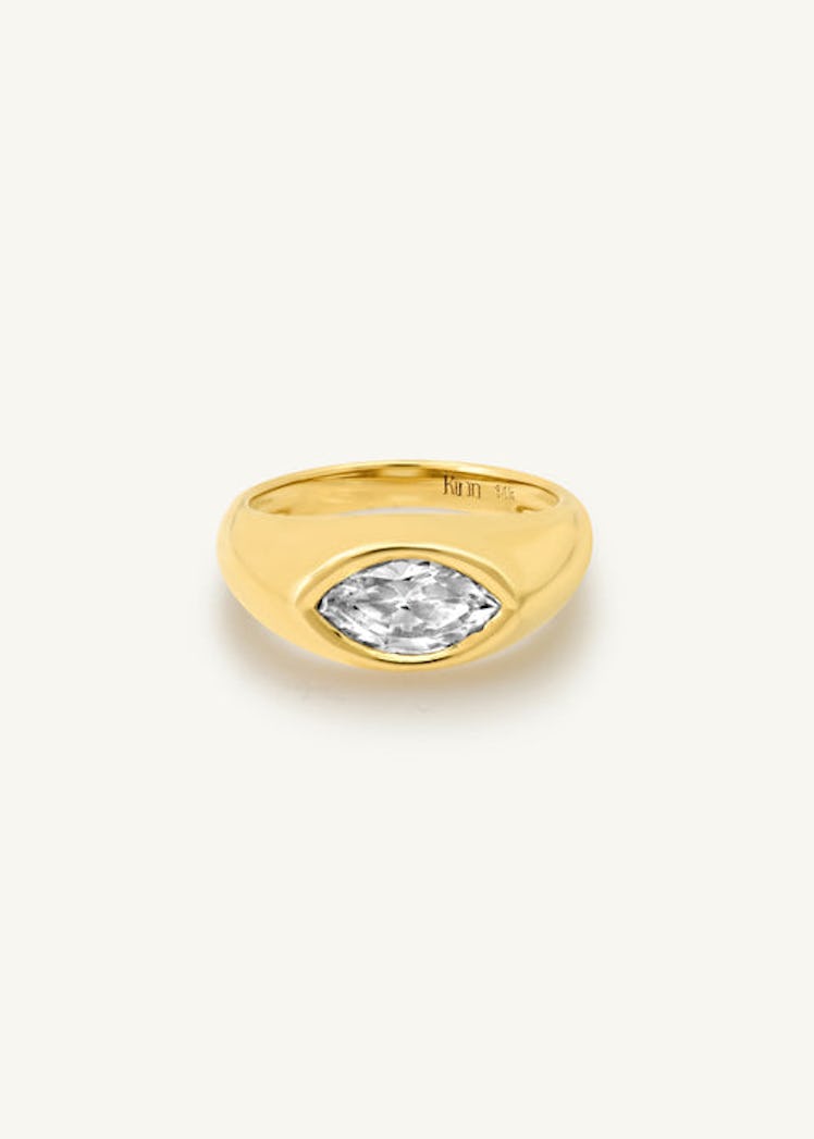 an east west bezel set marquise diamond engagement ring