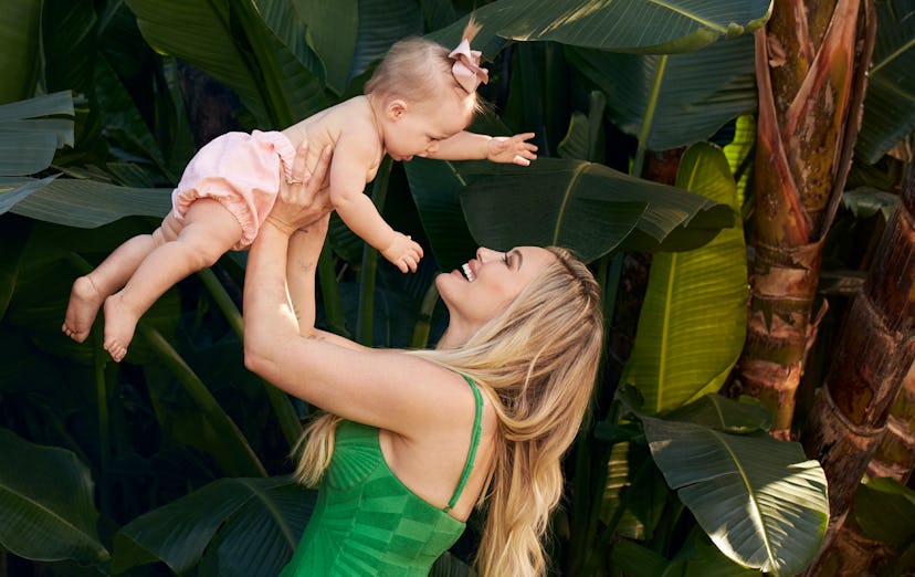 Hilary Duff lifting her daughter up in the air.