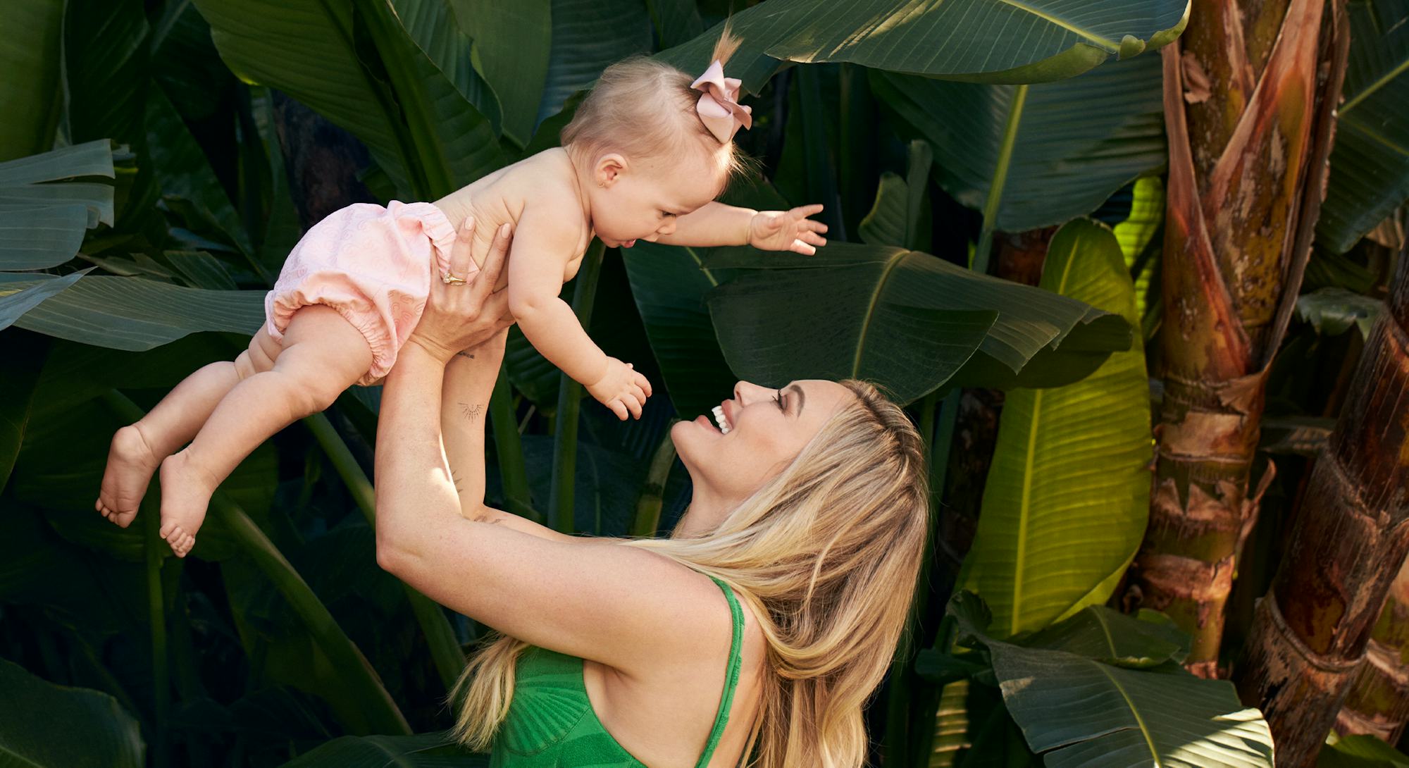 Hilary Duff lifting her daughter up in the air.