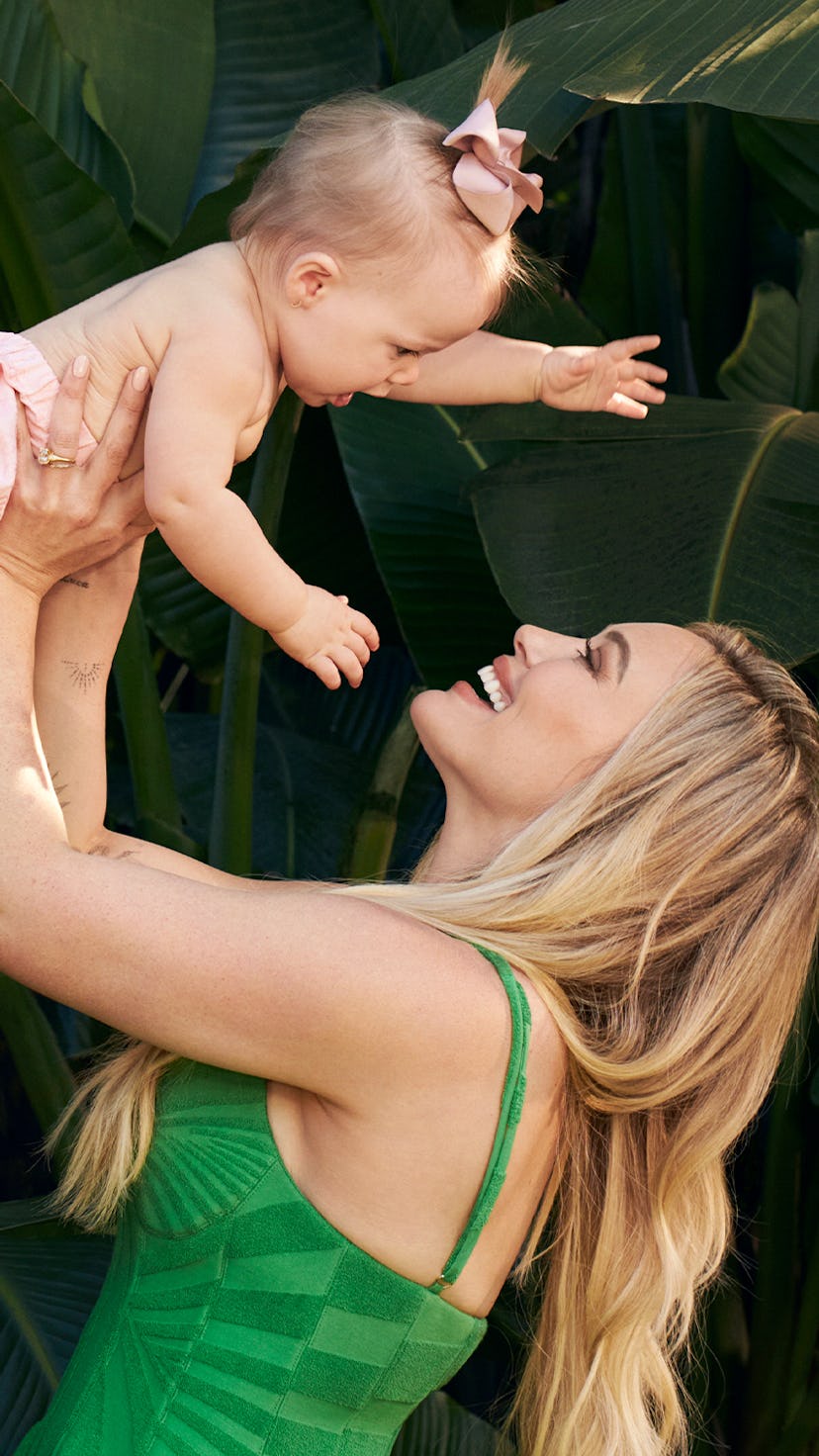 Hilary Duff lifting her daughter up in the air.